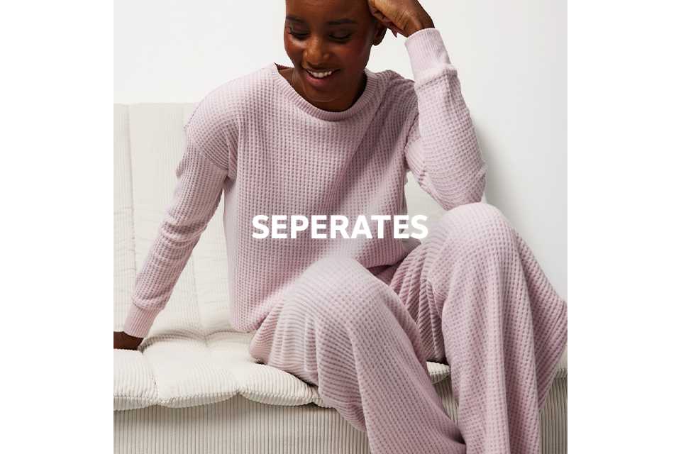 Textured pink waffle-knit loungewear set with long sleeves and matching trousers.