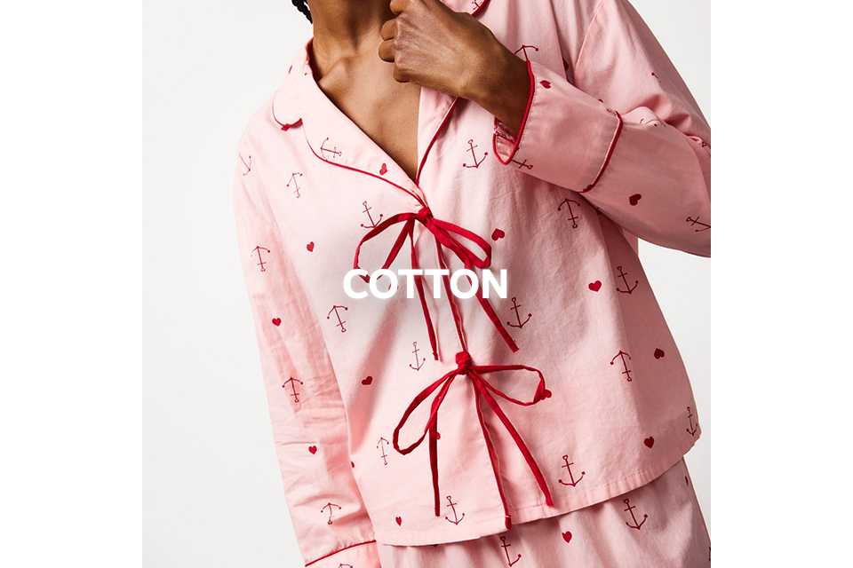 Pink cotton pyjama set with red anchor and bow print.