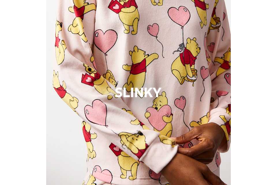 White slinky nightwear with Winnie the Pooh and pink balloon print.