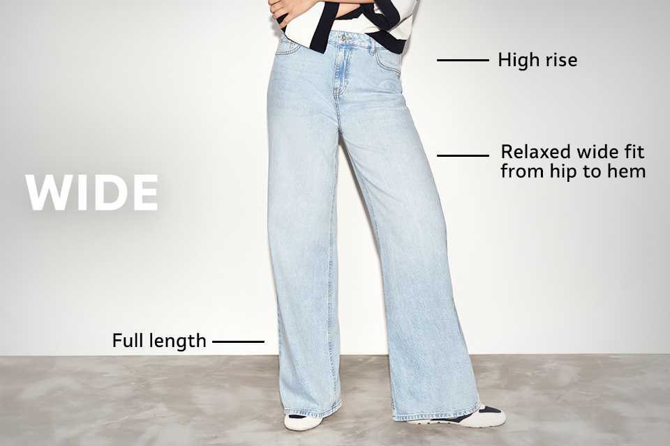 High-rise wide-leg jeans in light blue denim with relaxed fit from hip to hem and full-length design, styled with trainers.