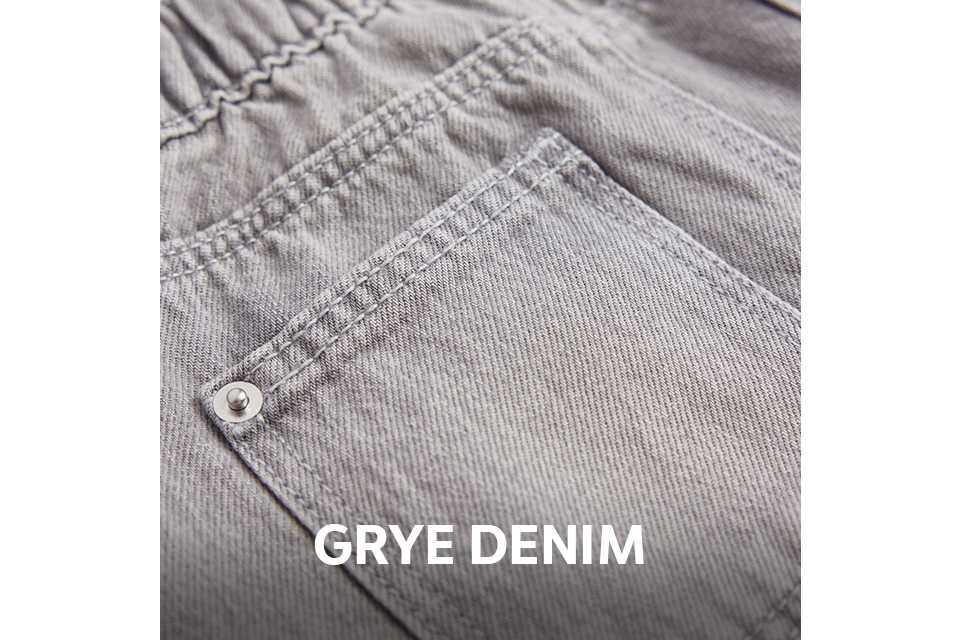 Close-up of the back of light grey denim jeans featuring an elasticated waistband, belt loops, and a back pocket with rivet detailing.
