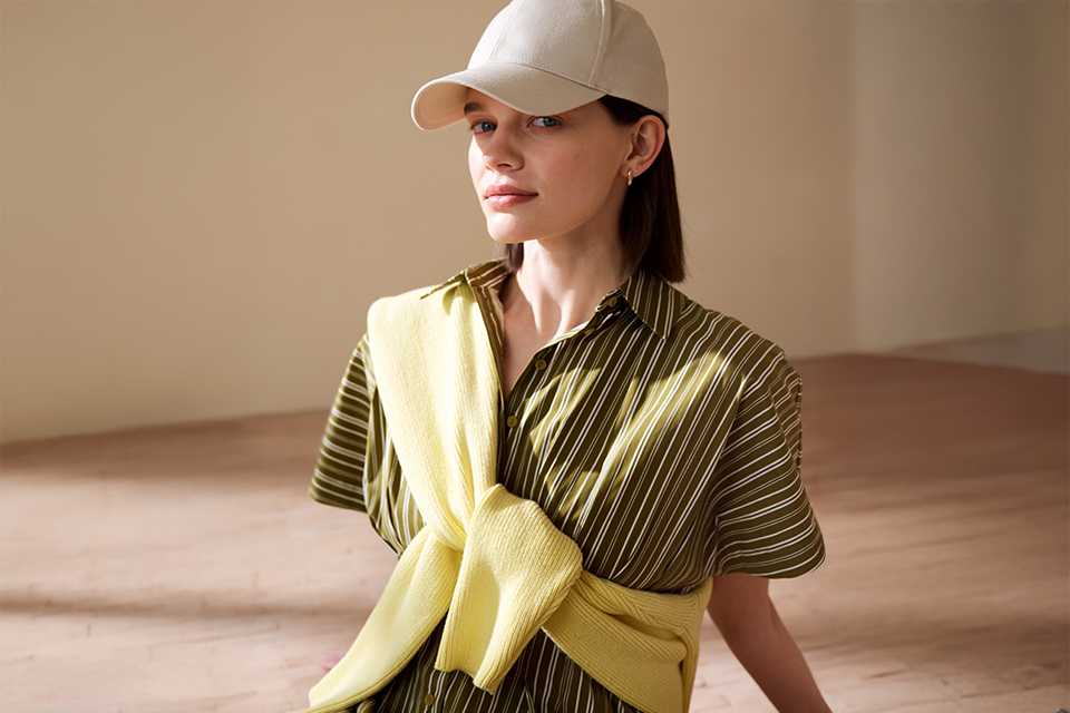 Green striped summer dress styled with a yellow shoulder bag, ideal for holiday packing and travel.