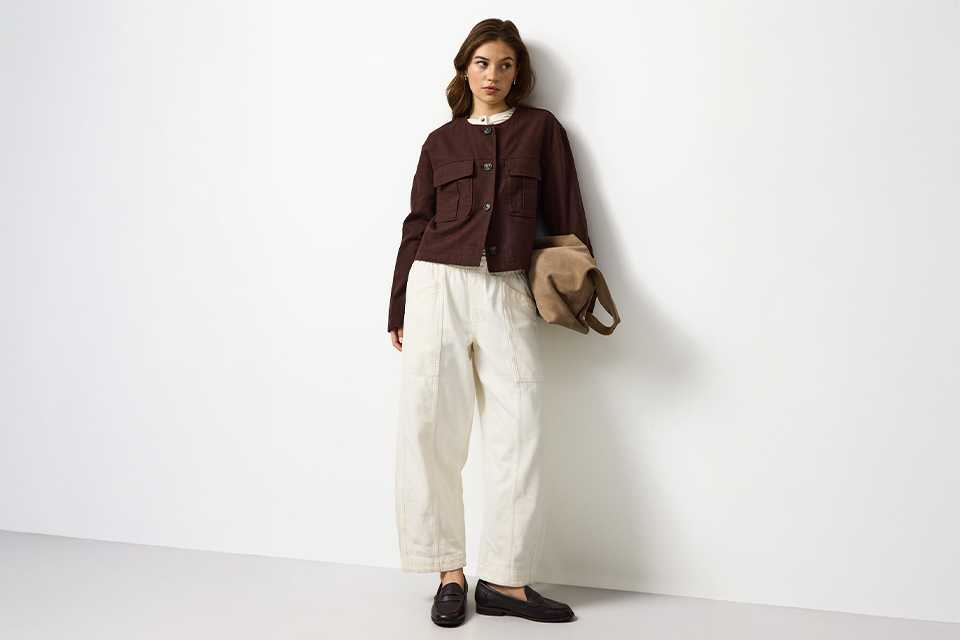 Linen summer outfit featuring a dark top and white wide-leg linen trousers for hot weather dressing.