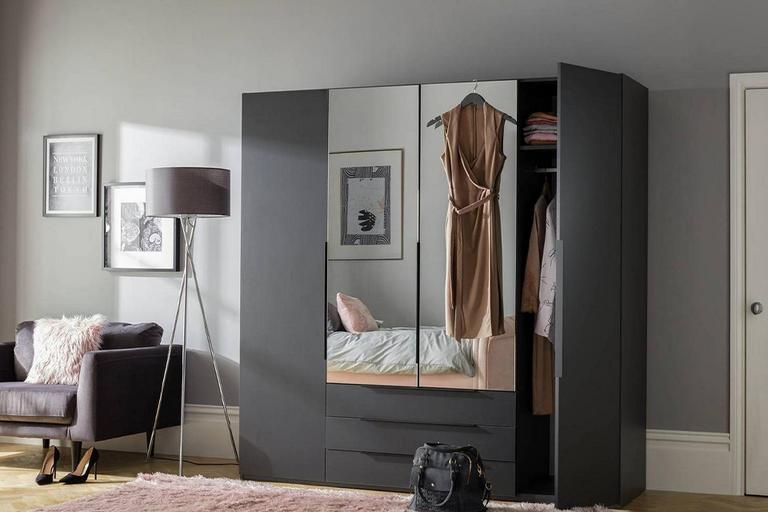 Black mirrored wardrobe in bedroom.