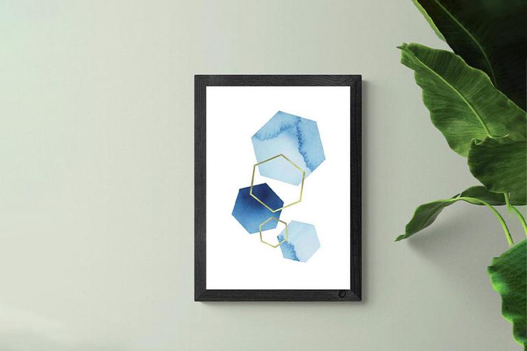 Blue geometric art print in black frame.