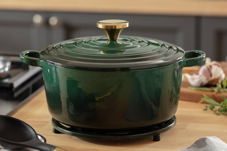 Green casserol dish on kitchen side.