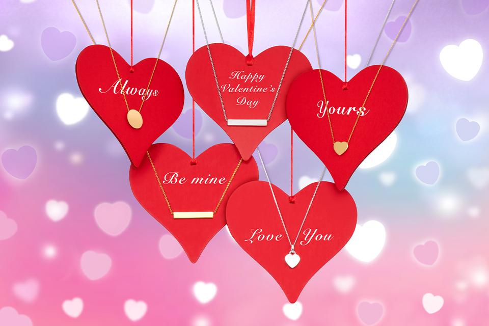 5 pieces of personalisable jewellery presented on hanging love heart displays.