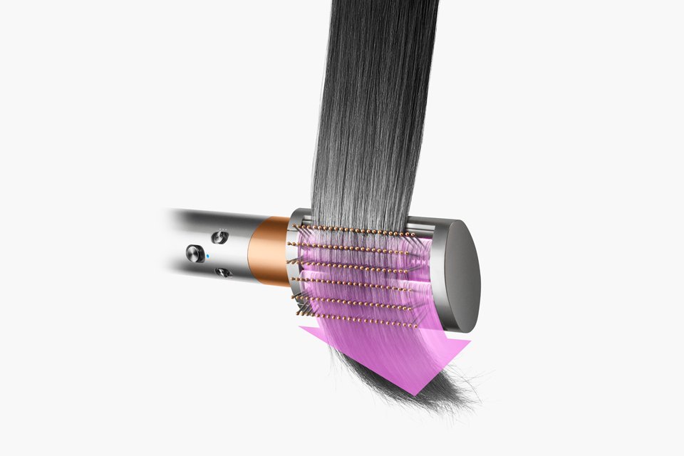 A close up of a soft brush being used to dry and style hair.