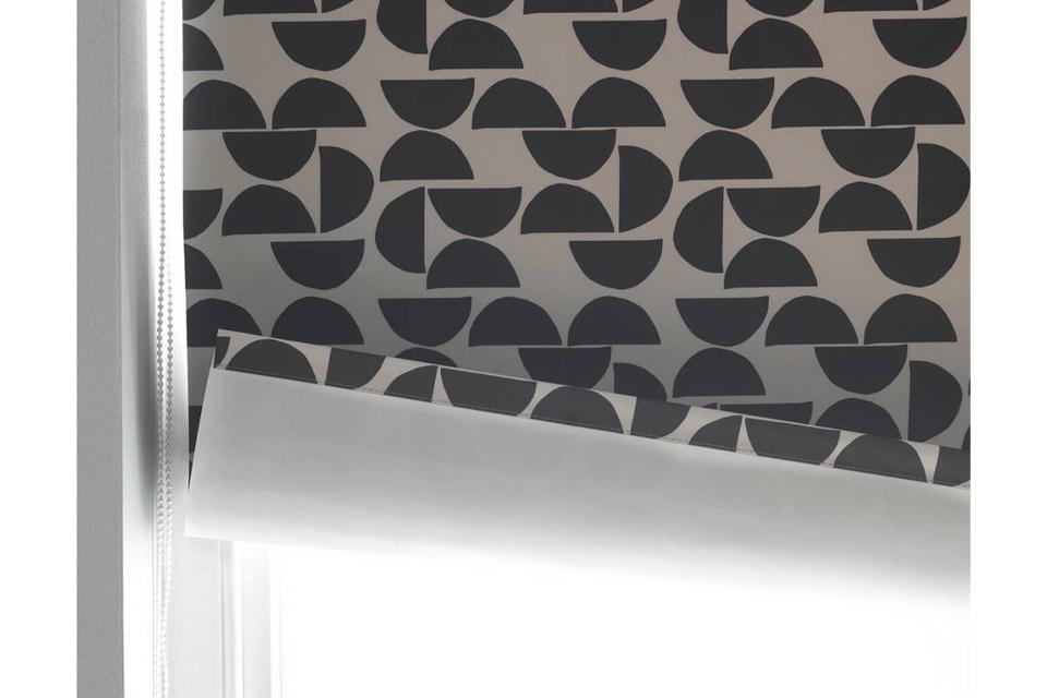Blackout blinds with a pink and grey pattern.