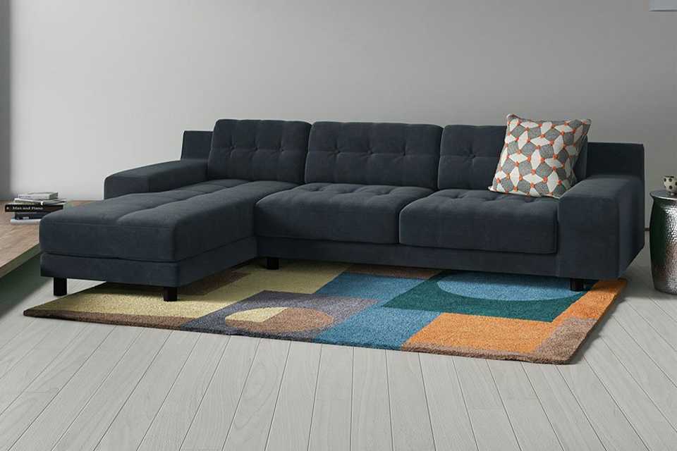 The charcoal Habitat William reversible corner fabric chaise in a smart lounge setting.