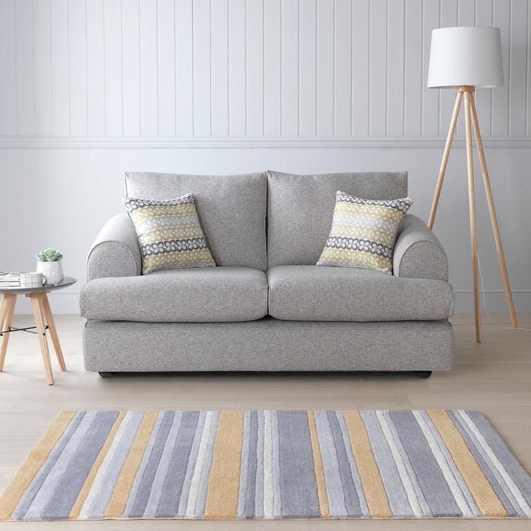 The silver Argos Home Megan 3-seater fabric sofa in a glam lounge setting.