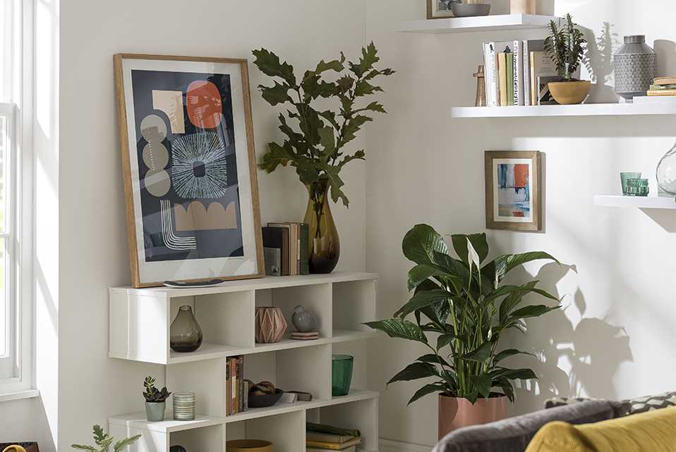 Image of a living room with shelving and a storage unit.