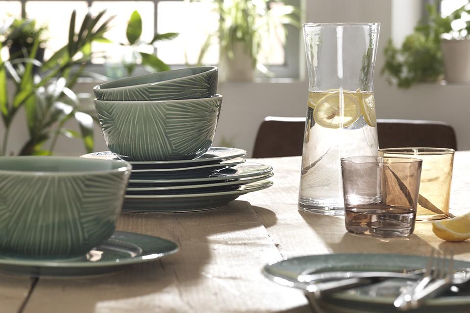 A range of green crockery and glassware.