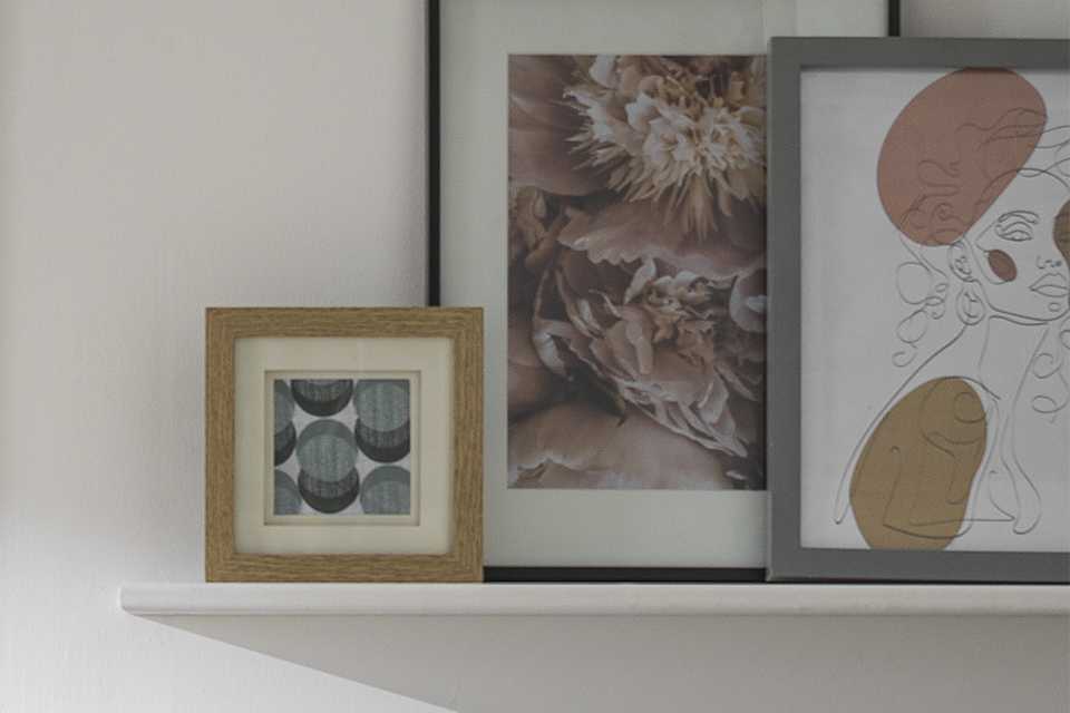 Range of frames in different styles and sizes on shelf.