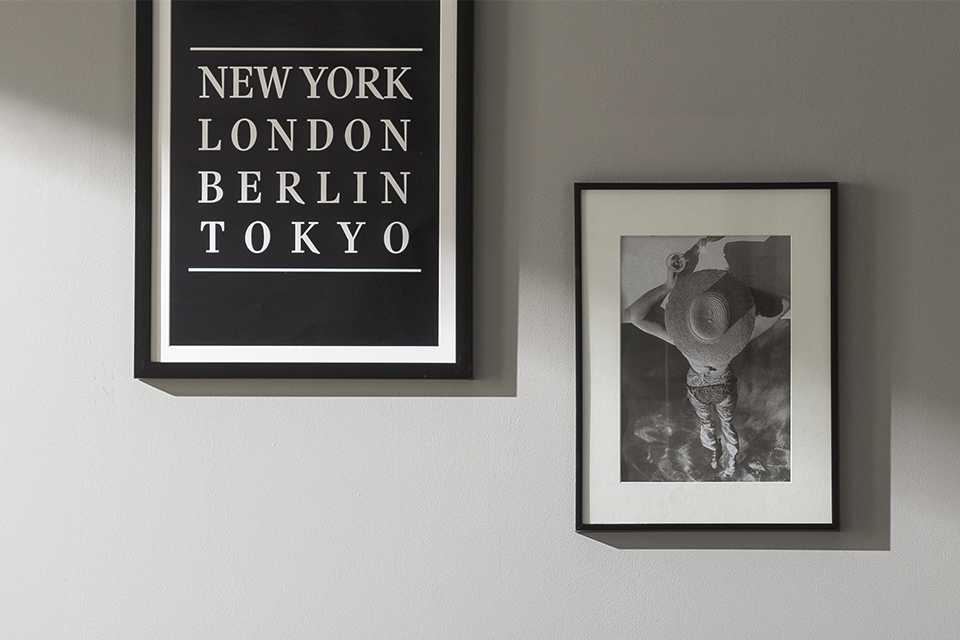 Wall art in black frames hanging on wall.