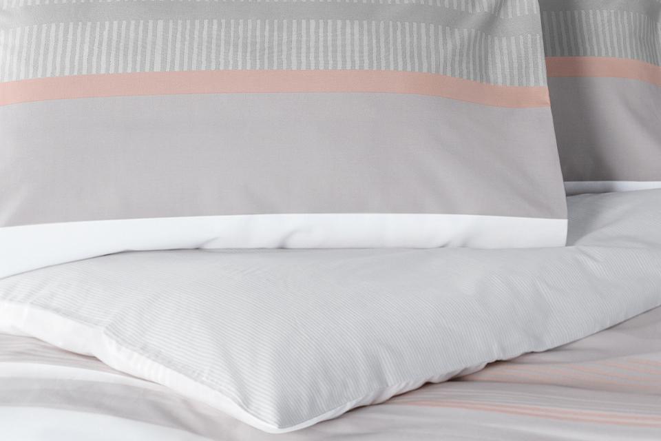 Image of grey and salmon coloured cotton bedding.