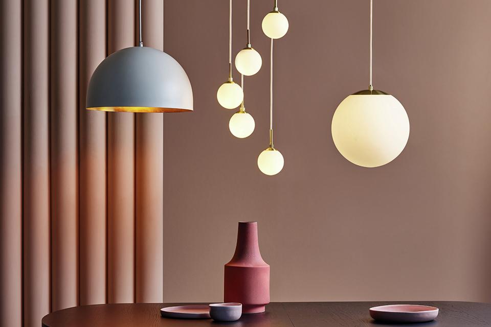 Image of various pendant styles hanging over a dining table.