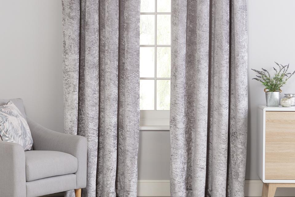 Grey crushed velvet curtains in a living room.