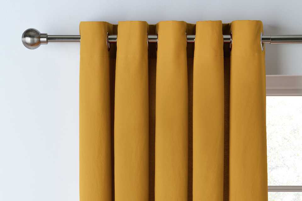 Mustard velvet eyelet curtains.