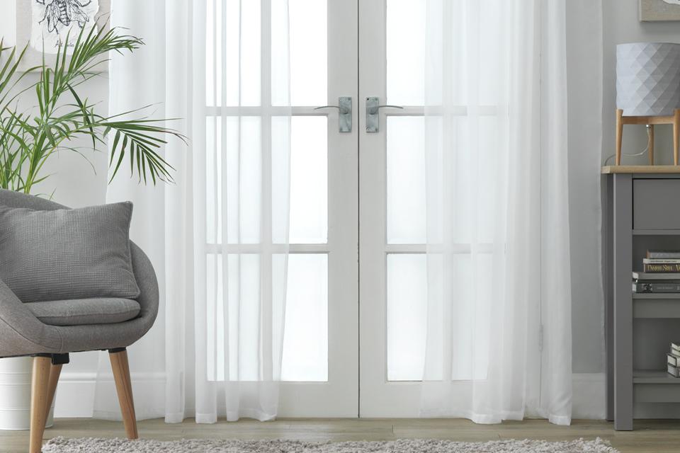 Sheer voile curtains in a living room.