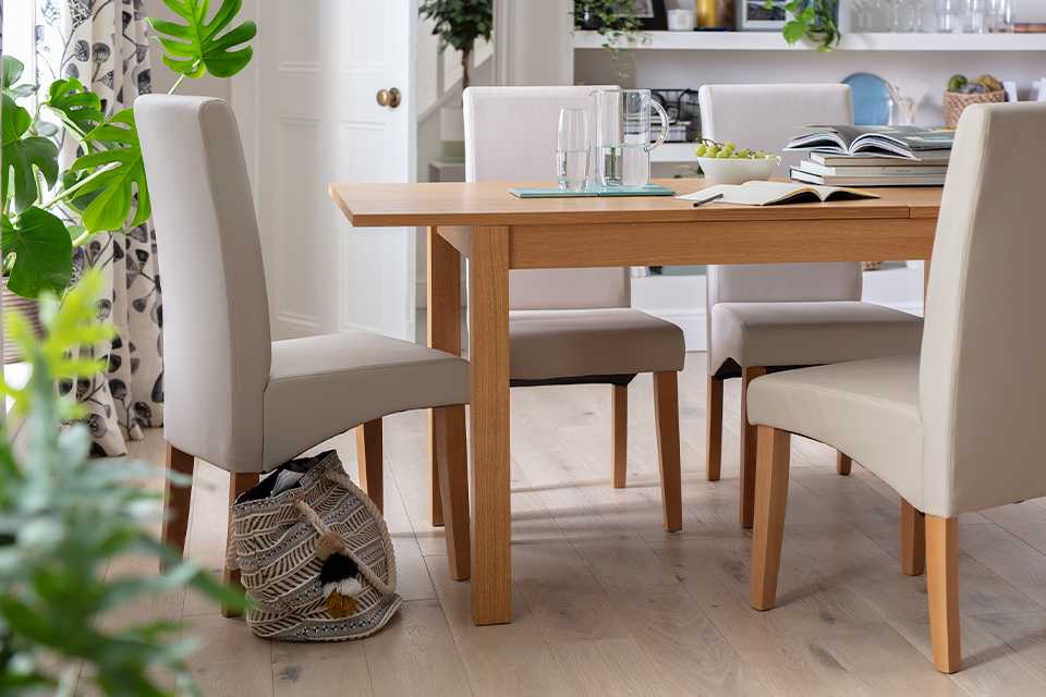 A rectangular wooden dining table with matching upholstered chairs.