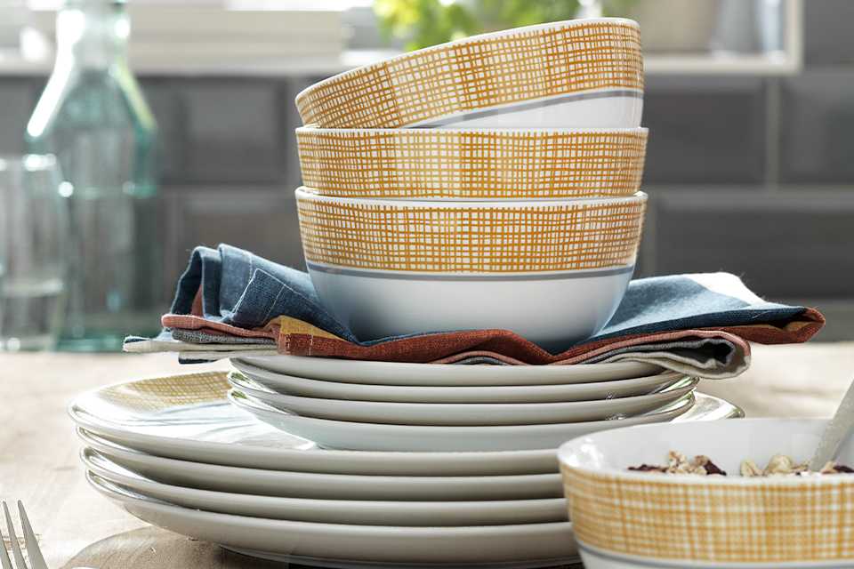 White stacked bowls with a grey and ochre pattern.
