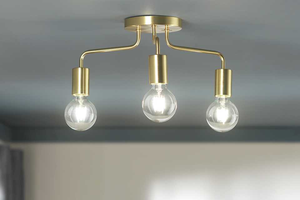 Brass ceiling light with three statement bulbs.