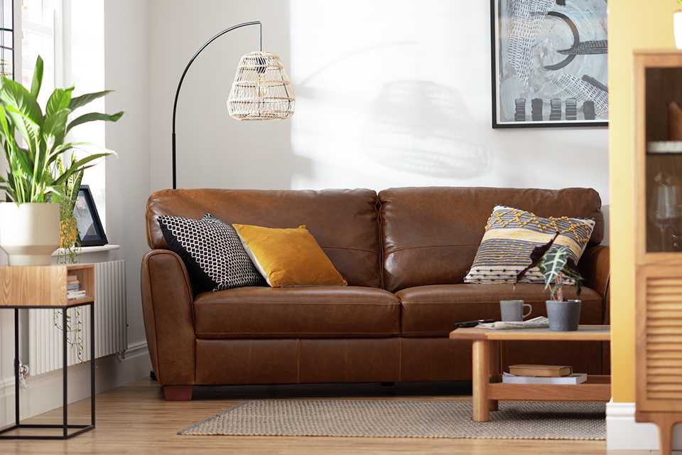 Image of leather sofa with cushions.