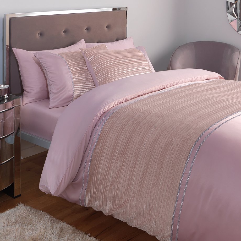 Pink bedding on bed.