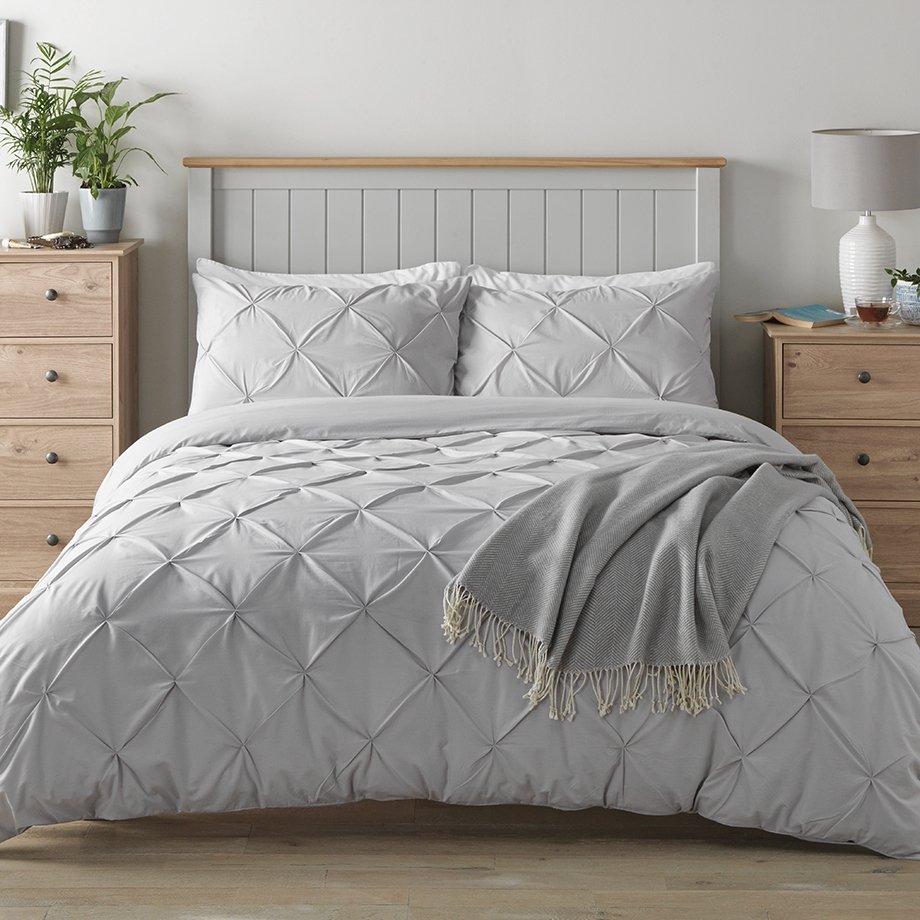 Grey bedding with diamond quilted design.
