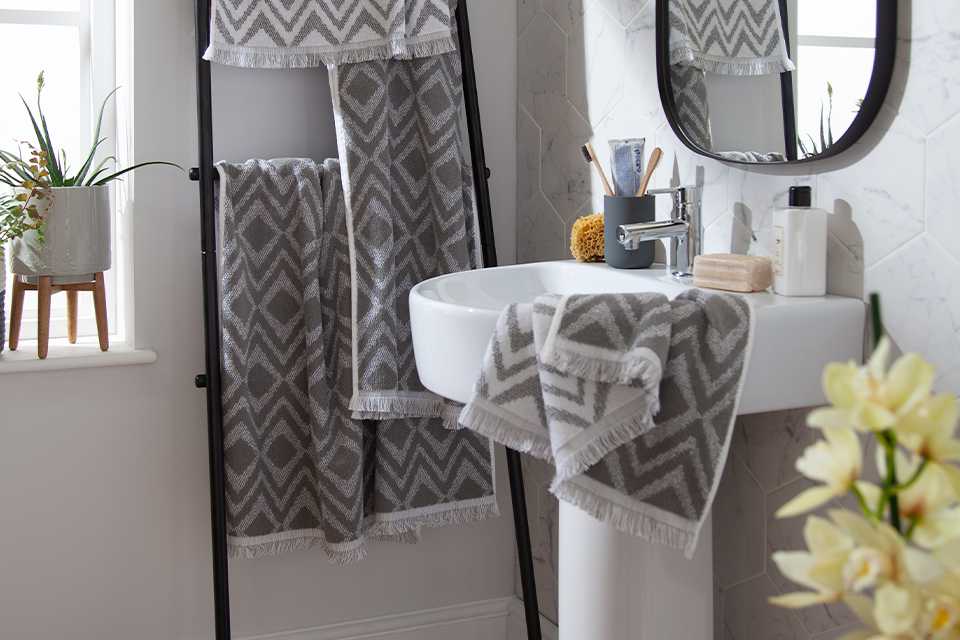 Grey patterned towels in bathroom.