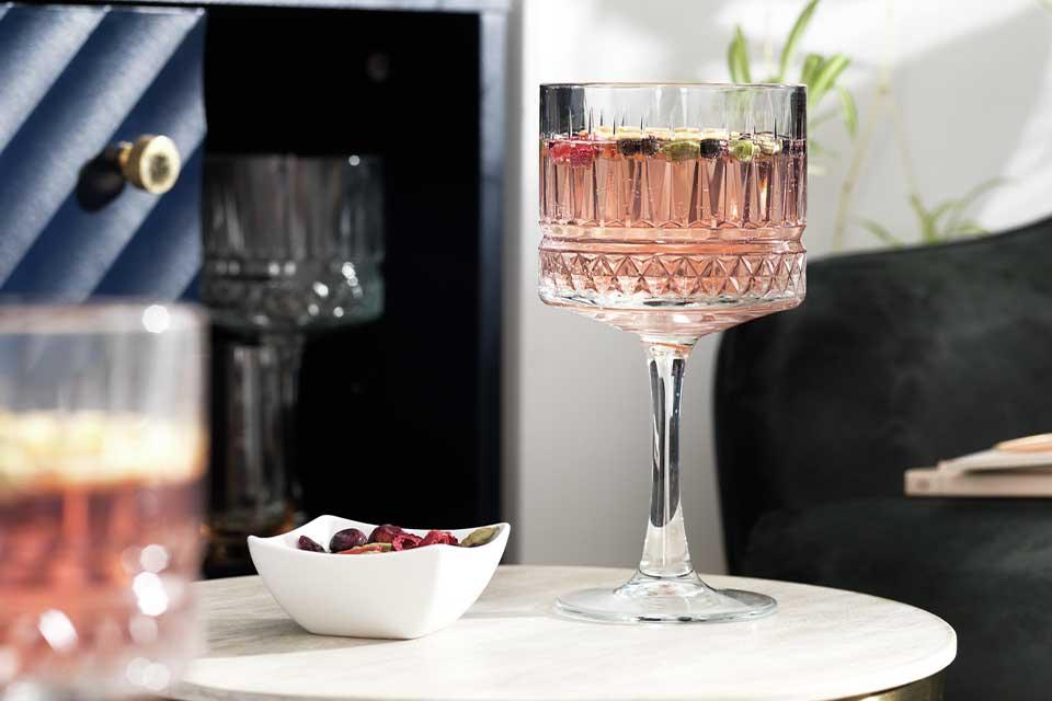 Image of a gin goblet with a pale pink cocktail in it.