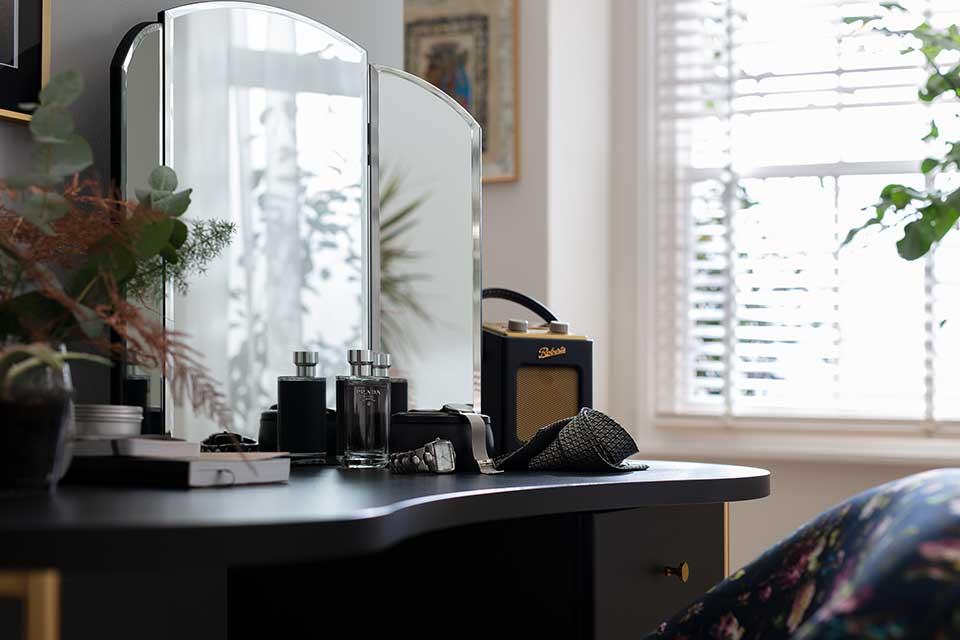 Image of a black dressing table with a triple dressing table mirror.