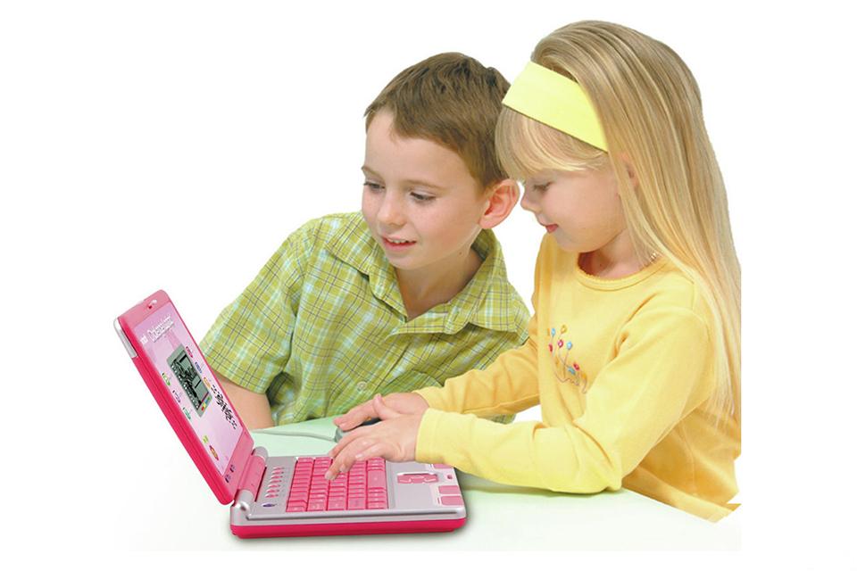A girl and a boy playing with the pink VTech Challenger Laptop.