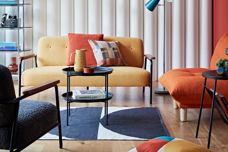 Image of yellow and orange sofa and chairs in a living room setting.