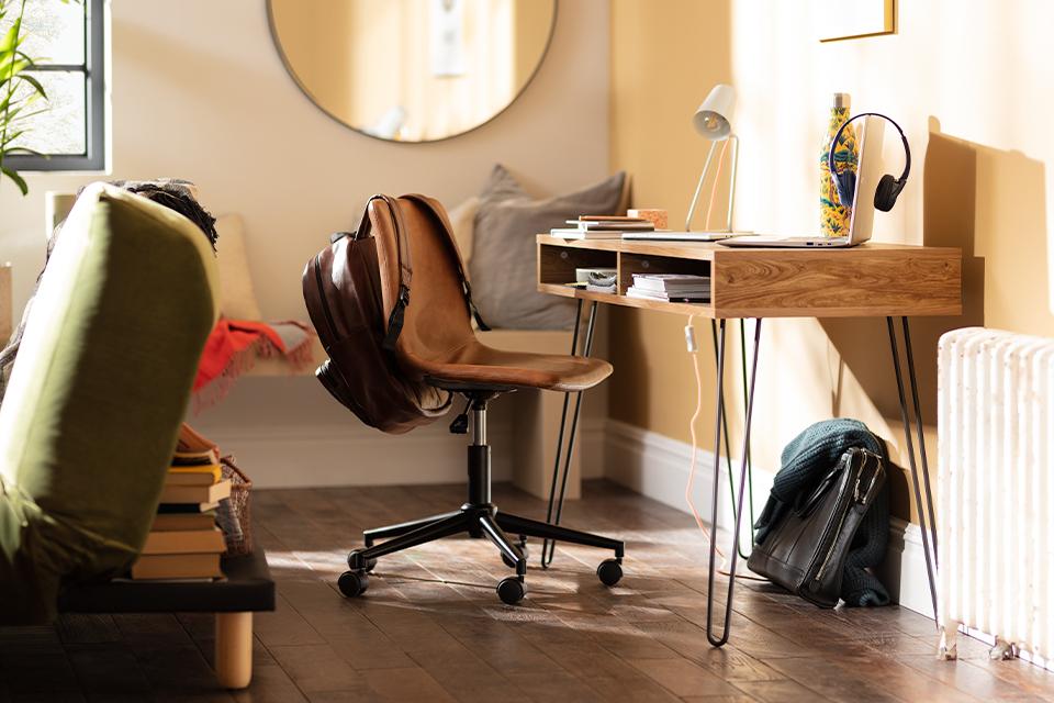 Image of a wooden desk with a brown. faux leather office chair.