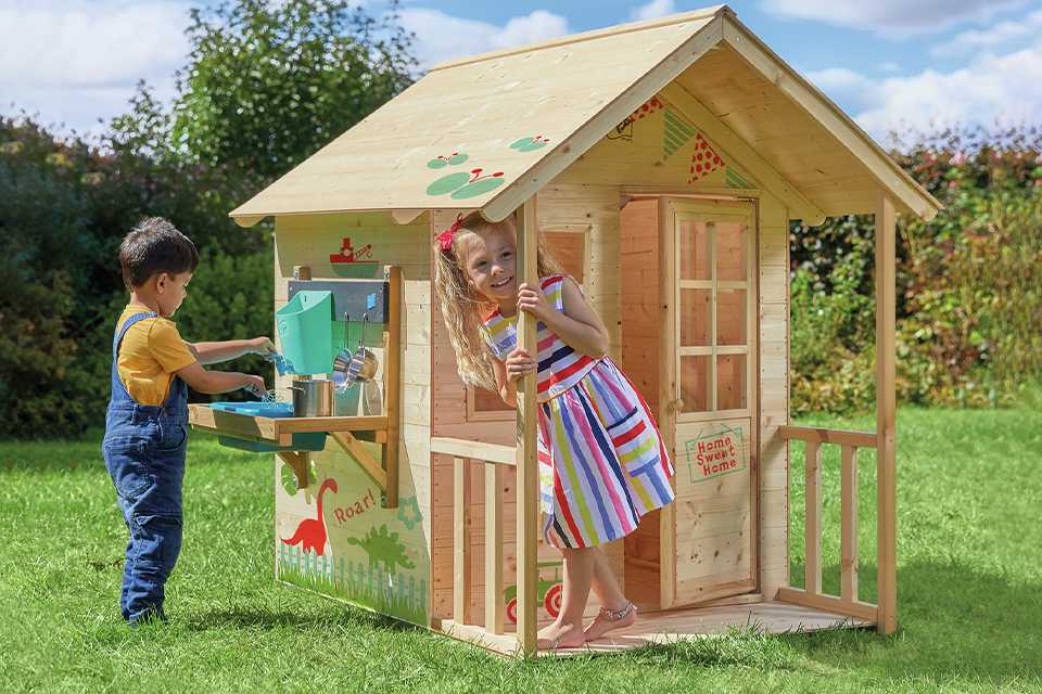 Children playing in the TP meadow cottage playhouse and kitchen.