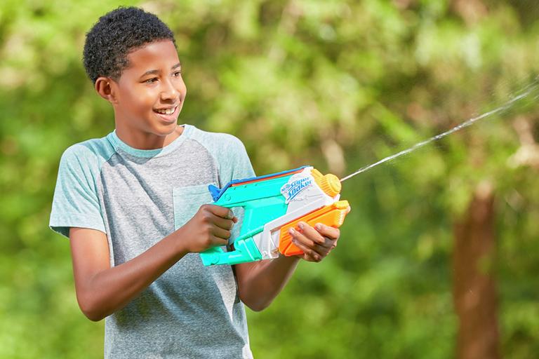 A boy squirting water from the Nerf Super Soaker splash mouth.