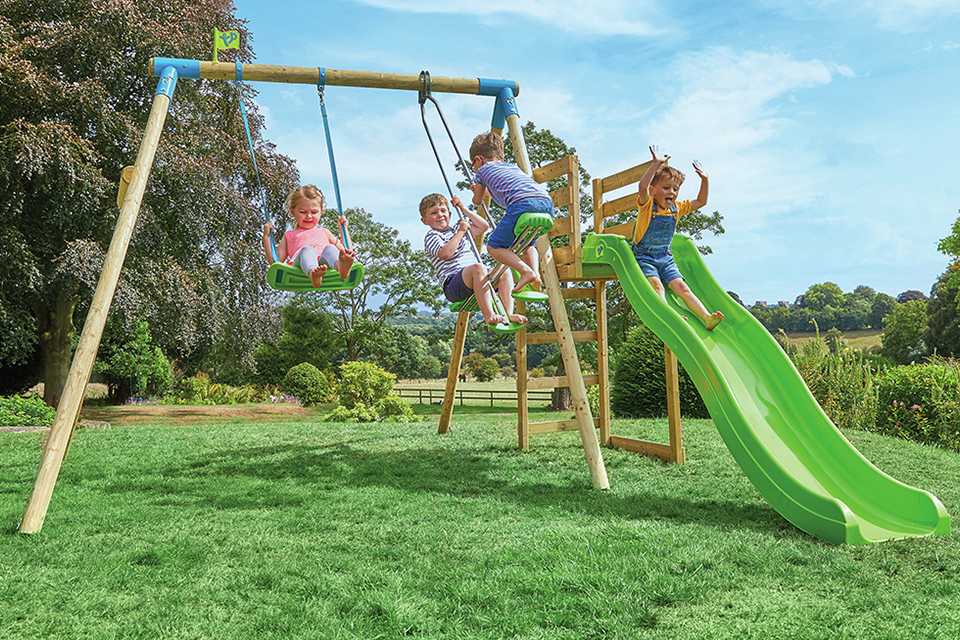 A group of kids playing outdoors on a swing set.