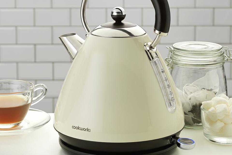 A cream Cookworks pyramid kettle on a kitchen side.