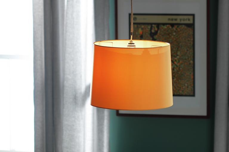 Image of an orange, fabric lampshade.