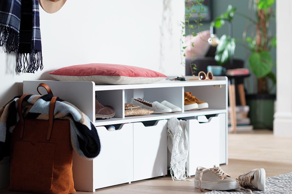 Image of a white bench with shoe storage beneath it.
