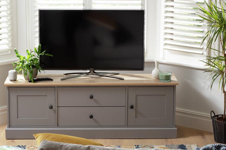 Image of a grey TV unit with storage compartments.