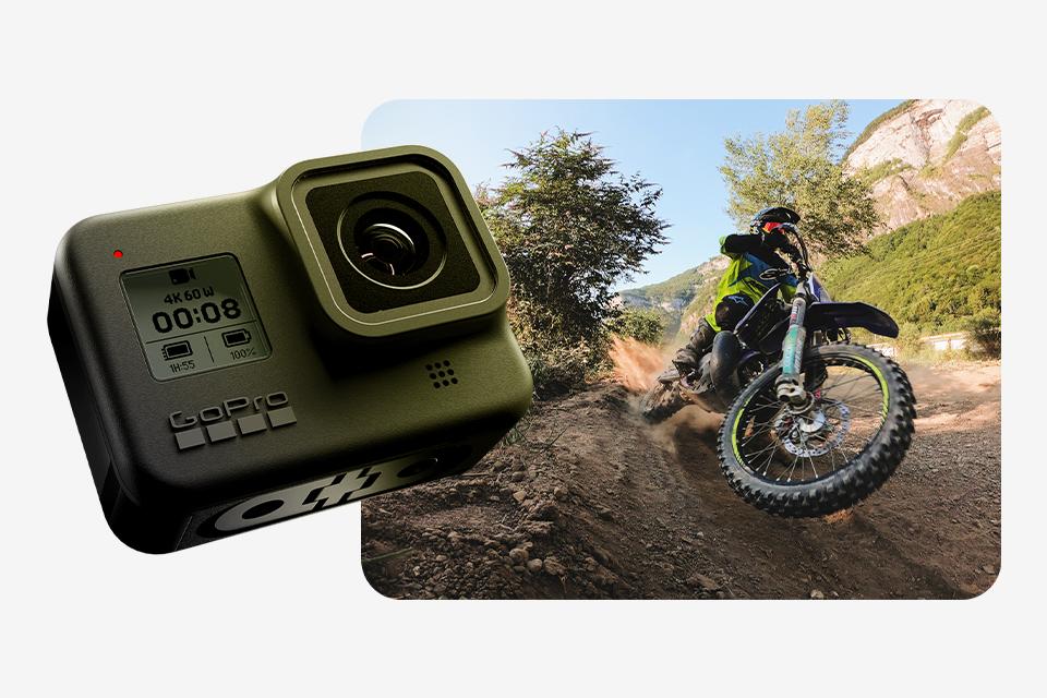 A GoPro HERO8 Black action camera next to an image of a man riding an off-road motorcycle.