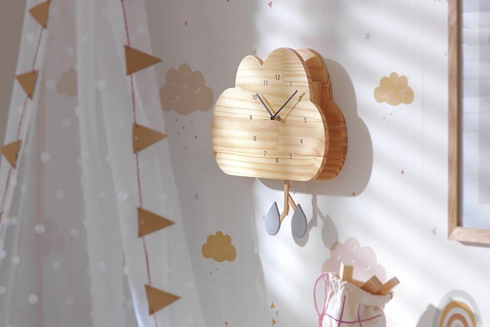 A Habitat kids wooden cloud wall clock in a kids bedroom.
