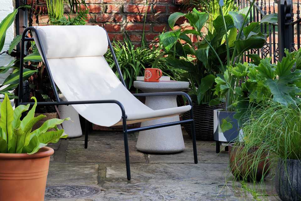 Habitat Teka metal garden chair in cream colour.
