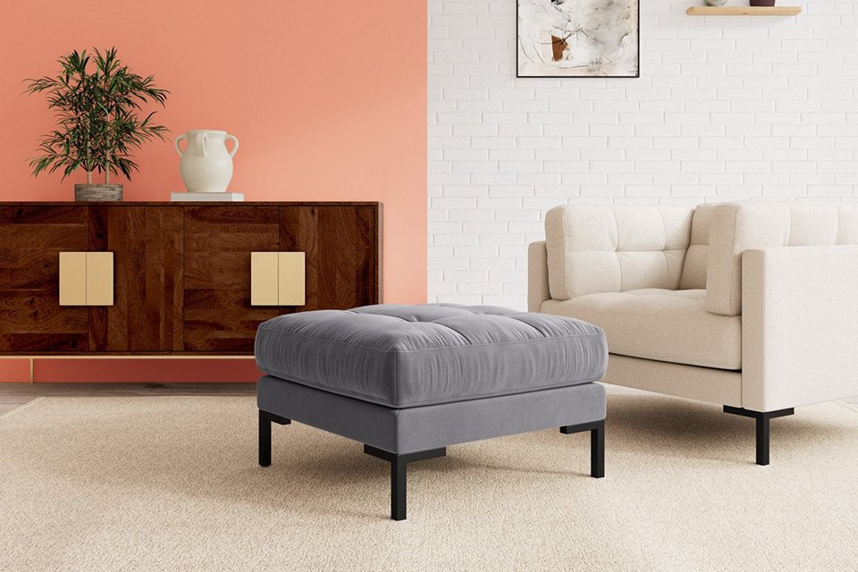 Grey ottamon in living room.