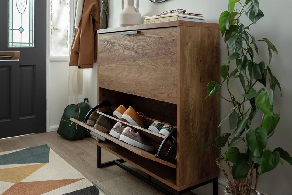 Wooden shoe storage in hallway.