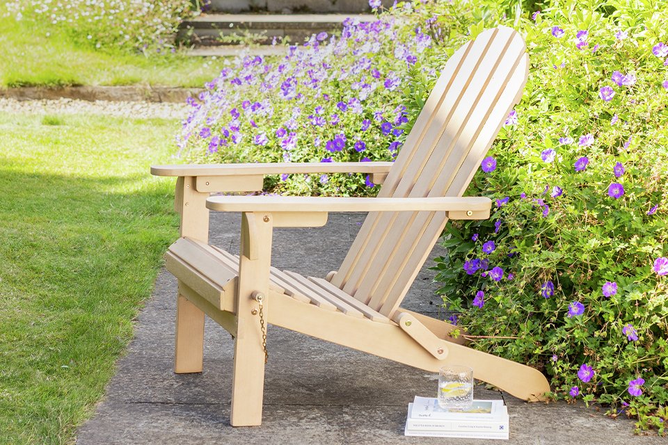 An Argos Home Adirondak natural wooden garden chair.