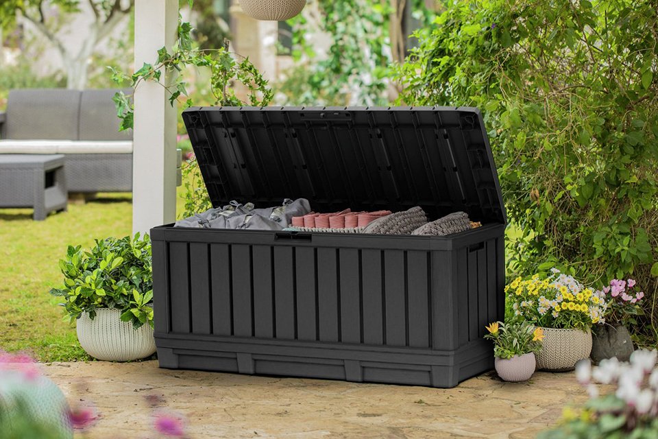 Keter Kentwood 350L Outdoor Garden Storage Box in grey colour placed outdoors. 